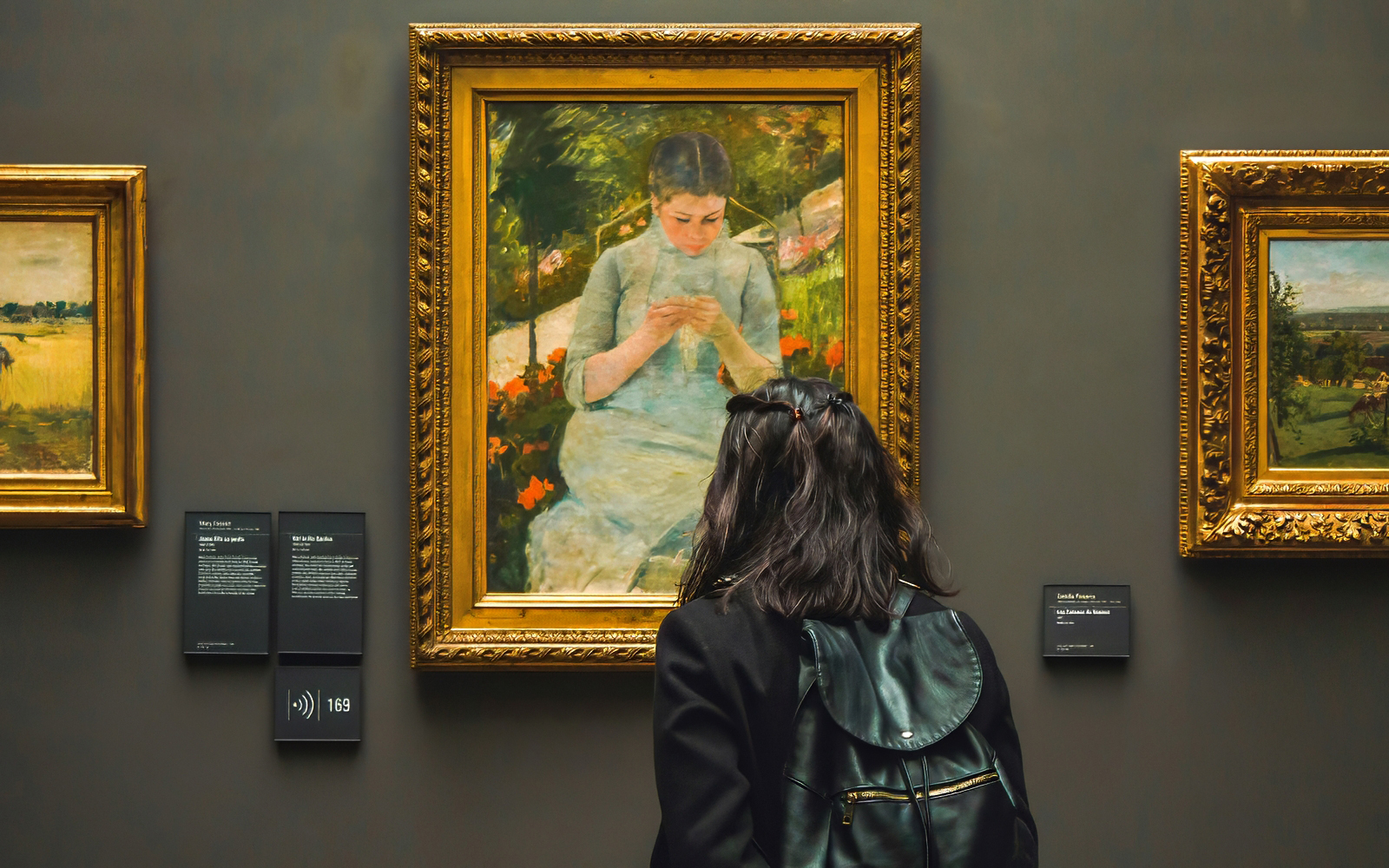 Visitor viewing Mary Cassatt's "Young Girl In The Garden" at d’Orsay Museum, Paris.