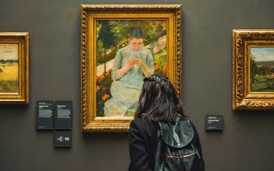 Visitor viewing Mary Cassatt's "Young Girl In The Garden" at d’Orsay Museum, Paris.