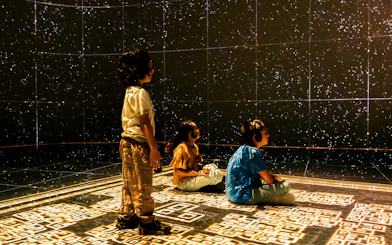 Children experiencing a starry projection at the London Timewalk Exhibition.
