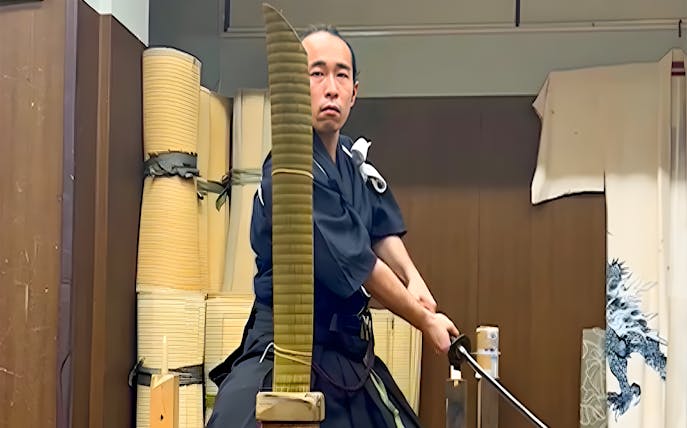 Samurai performing trial cutting with a katana in Tokyo theater.
