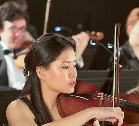 Violinist performing at a classical concert in Vienna.
