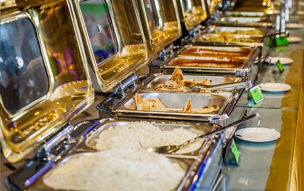 Buffet with Indian dishes on Chao Phraya Princess Cruise, featuring rice and naan.