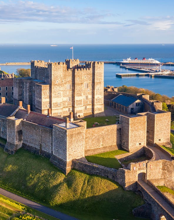 Dover Castle overlooking the English Channel with a cruise ship in the background.