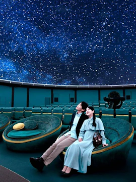 Couple enjoying starry sky at Konica Minolta Planetaria TOKYO Ginza.