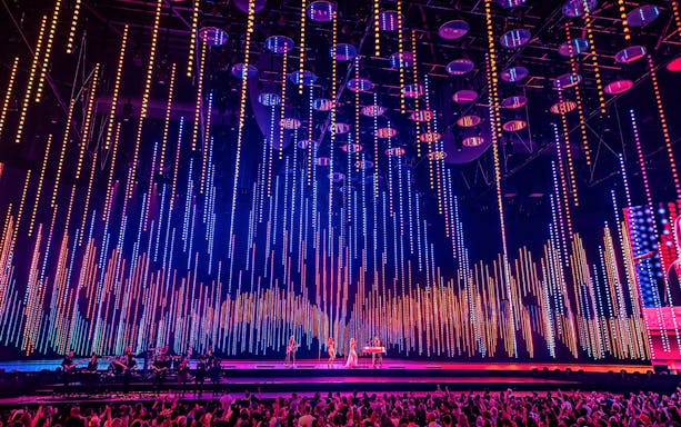 ABBA Voyage concert stage with colorful light display in London.