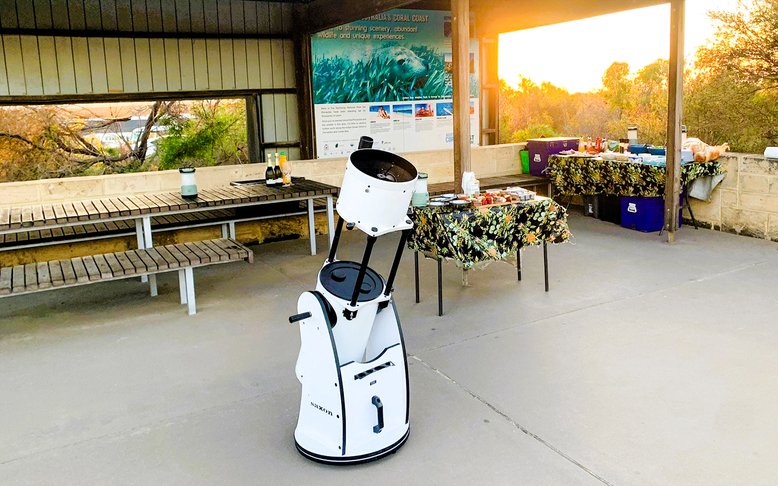 Telescope setup for Pinnacles Sunset & Stargazing Tour with picnic tables and sunset view.