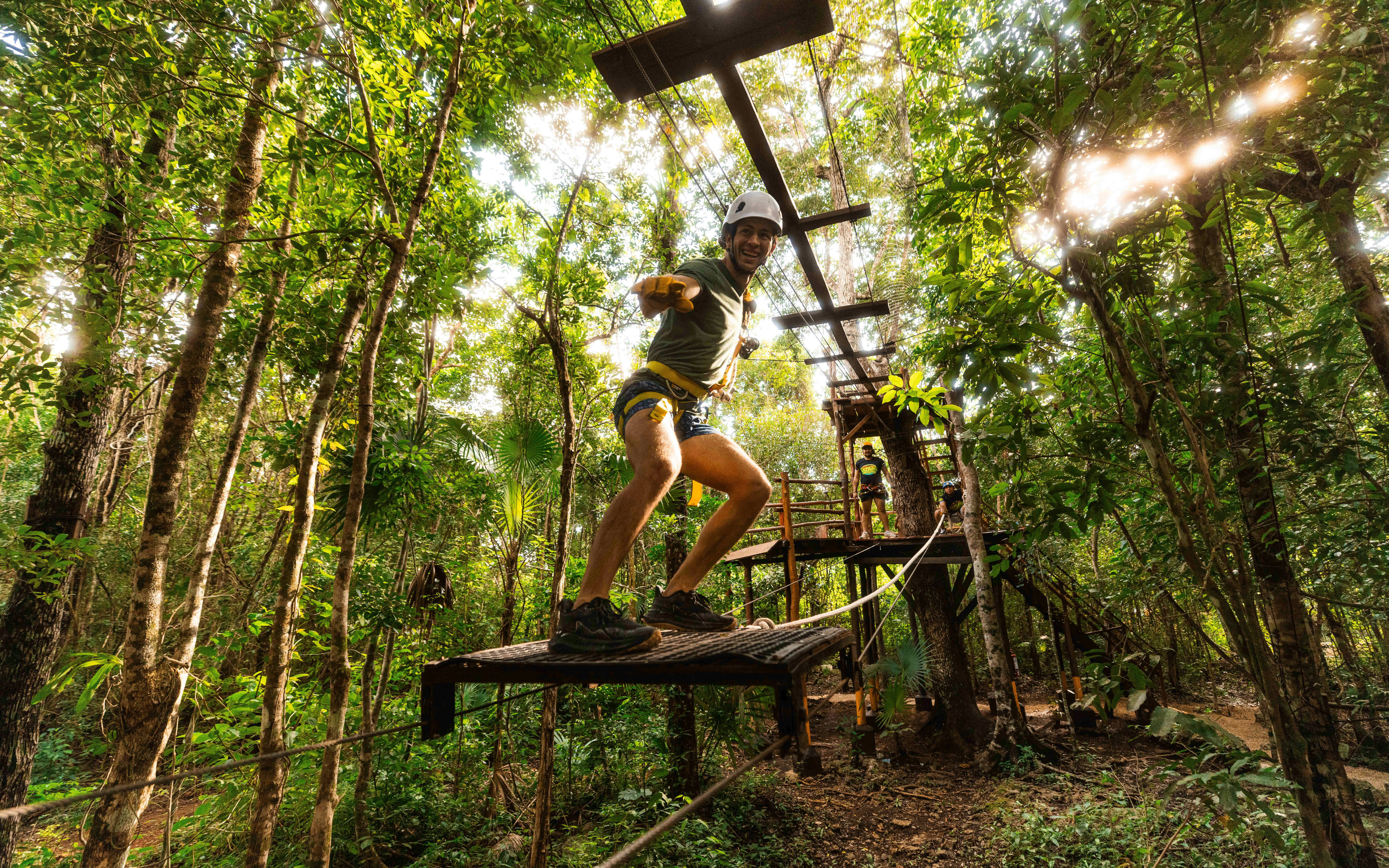 Adventurer crossing a rope bridge in Cancun Extreme Adventuring Park.