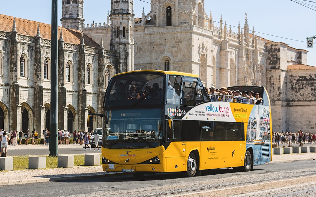 Lisbon hop-on hop-off bus passing Jerónimos Monastery.