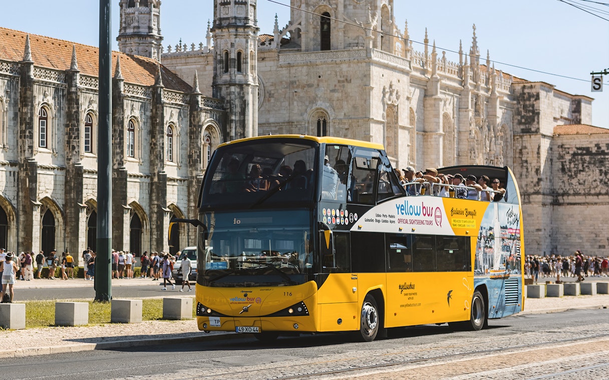 Lisbon hop-on hop-off bus passing Jerónimos Monastery.