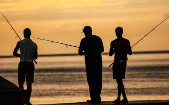 Atlantic shore fishing at sunset in Oualidia, Essaouira.