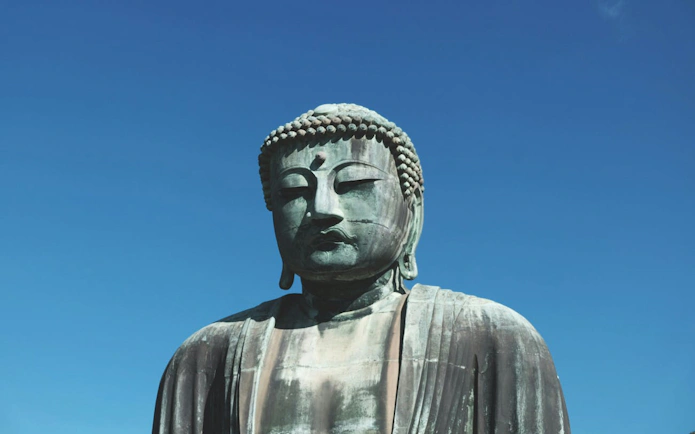 Kamakura Great Buddha statue under clear blue sky.