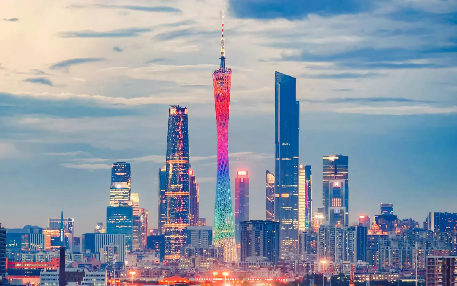 Canton Tower illuminated at night above Guangzhou's Zhujiang New Town skyline, Guangdong, China.