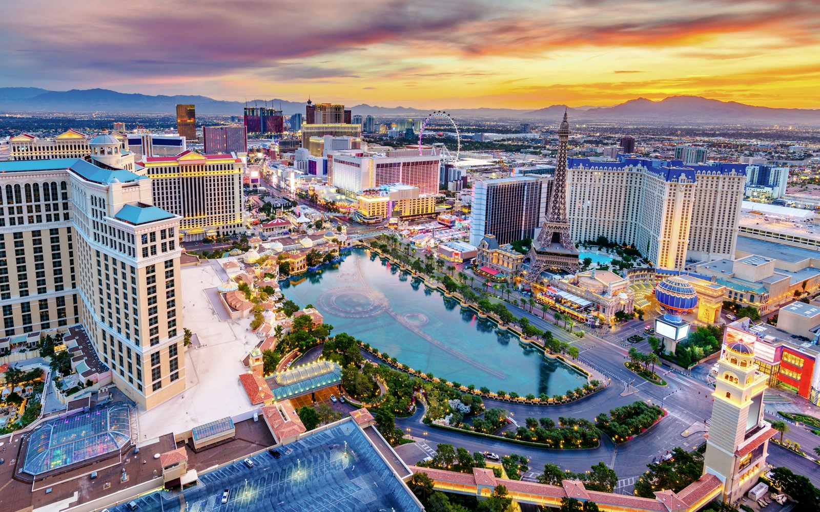 Las Vegas skyline at dusk with hotels and replica Eiffel Tower, Nevada, USA.