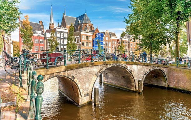 Bicycles on Blue Bridge over canal in Amsterdam during self-guided city audio tour.