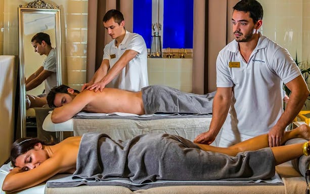 Couples receiving massages at Pesterzsebet Bath, Budapest.