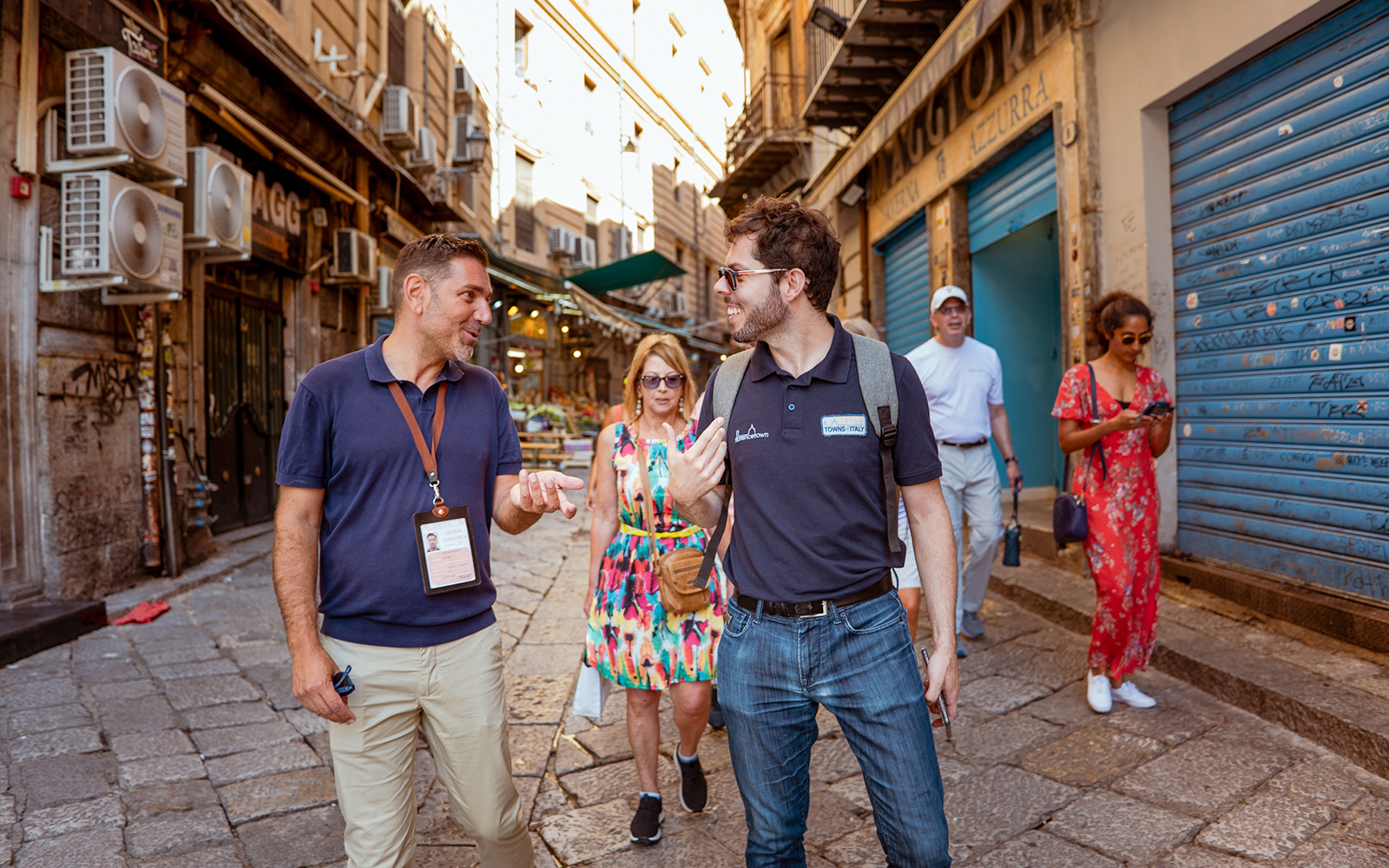 Tourists walking through a historic street in Palermo during a UNESCO Sites Walking Tour.