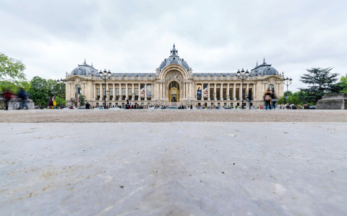 Petit Palais facade in Paris with ornate architecture and people walking nearby.