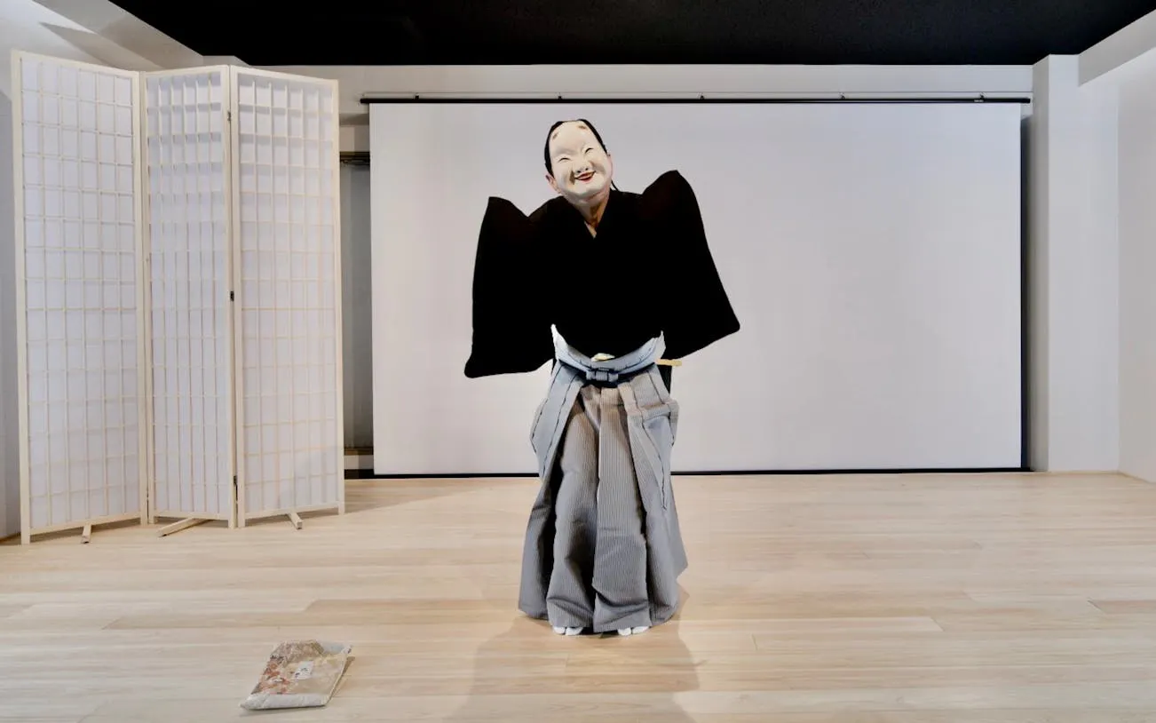 Noh performer in traditional costume during Kyoto theater workshop.
