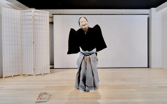 Noh performer in traditional costume during Kyoto theater workshop.