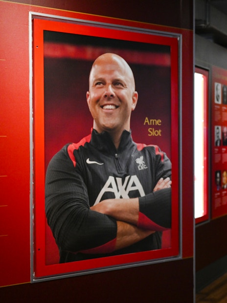 Portrait and tribute to a Liverpool FC figure inside Anfield Stadium.