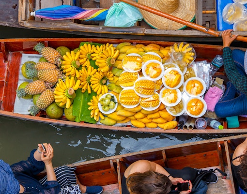 Vendor selling food on a boat in Pattaya’s Floating Market