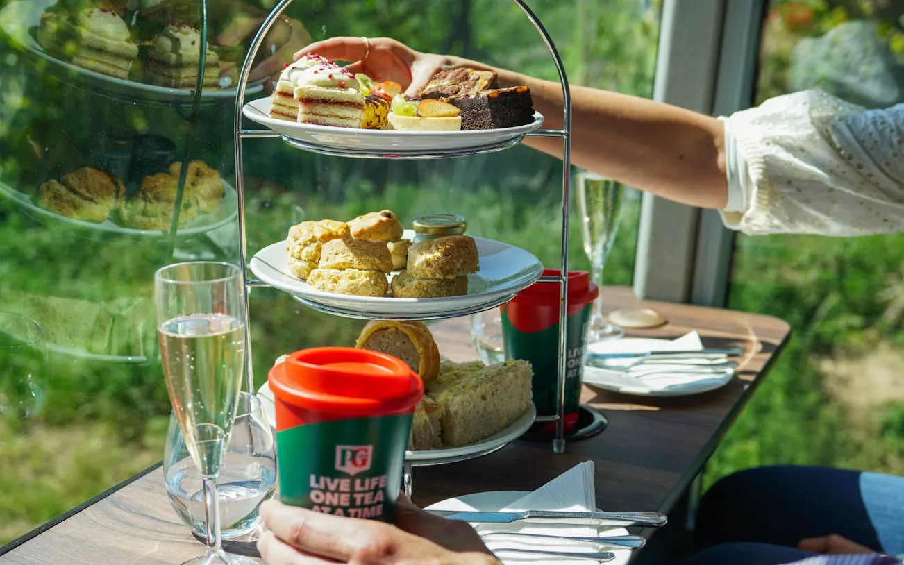 Afternoon tea with scones and cakes on a London sightseeing bus tour.