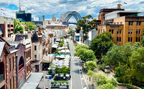 Historic street view with cafes and Sydney Harbour Bridge in the background, Sydney.