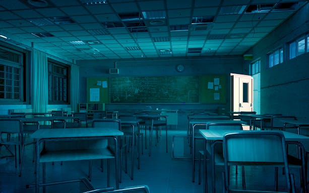 Dimly lit classroom with empty desks and an open door at Harrowing Halloween 3, Singapore Discovery Centre.