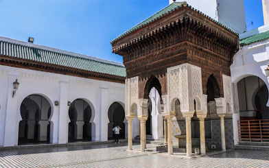 Courtyard of Al Quaraouiyine Mosque in Fes Medina, featuring intricate arches and tilework.