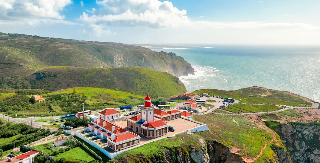 Cape Roca lighthouse on rugged cliff edge, Cabo da Roca, Portugal, Europe's westernmost point.