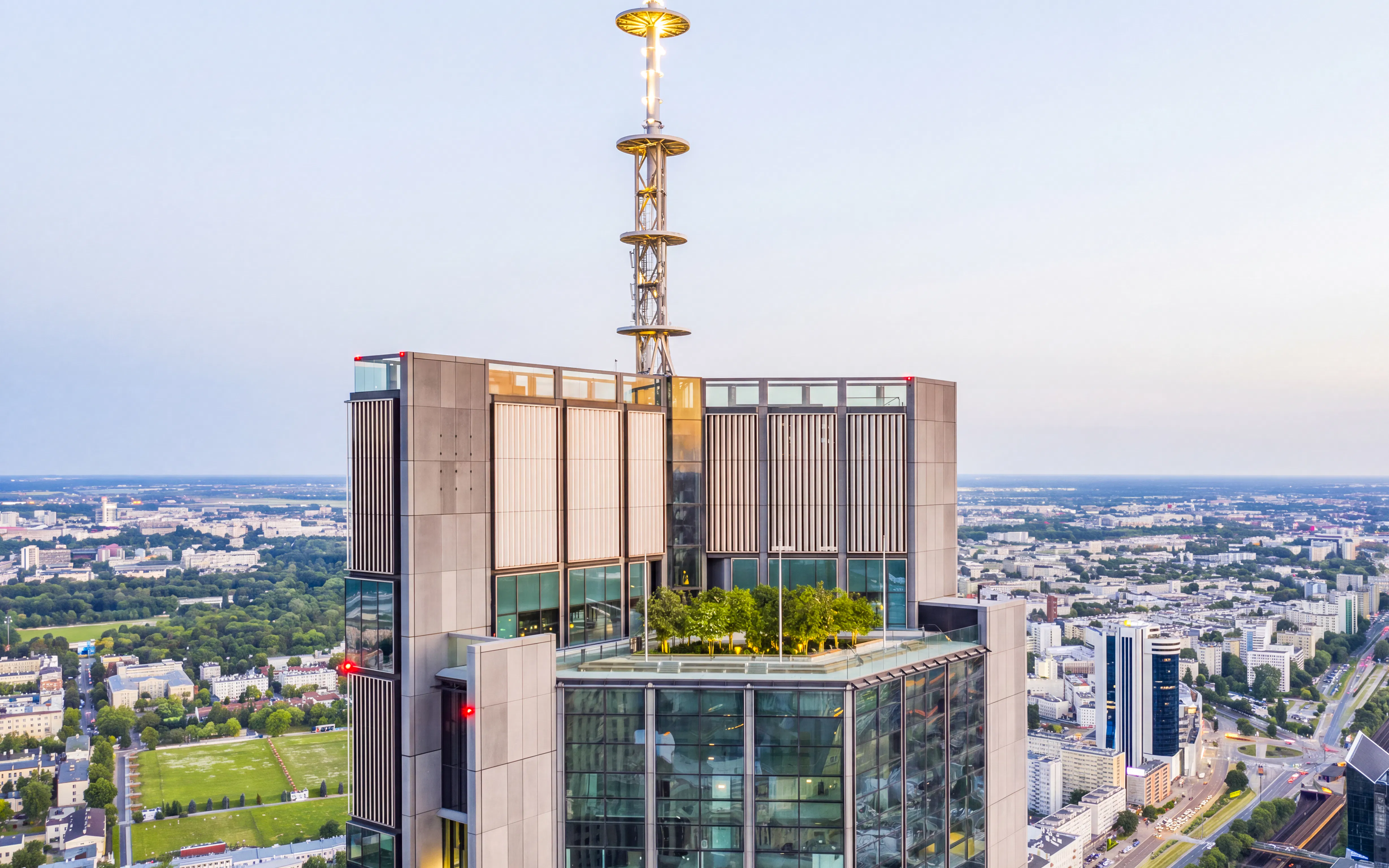 Highline Warsaw rooftop terrace with cityscape view and greenery.