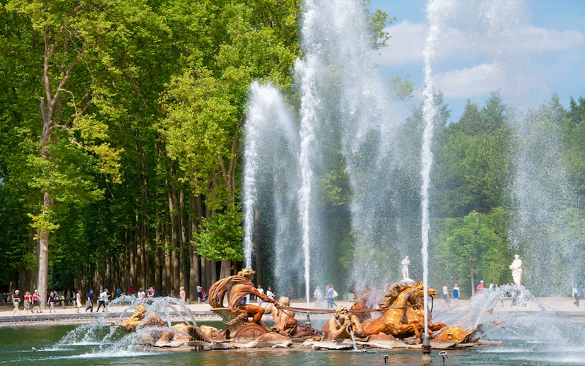 Fountain of Apollo with sculptures and water jets at Versailles Gardens, France.