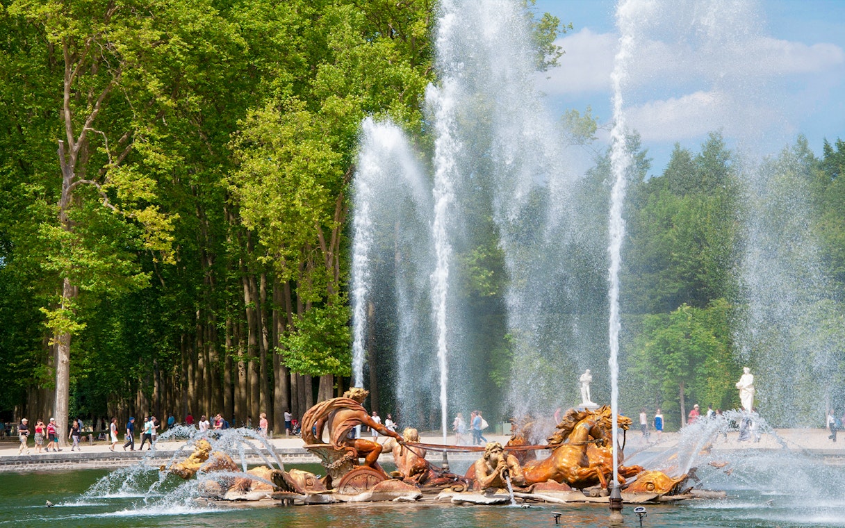 Fountain of Apollo with sculptures and water jets at Versailles Gardens, France.