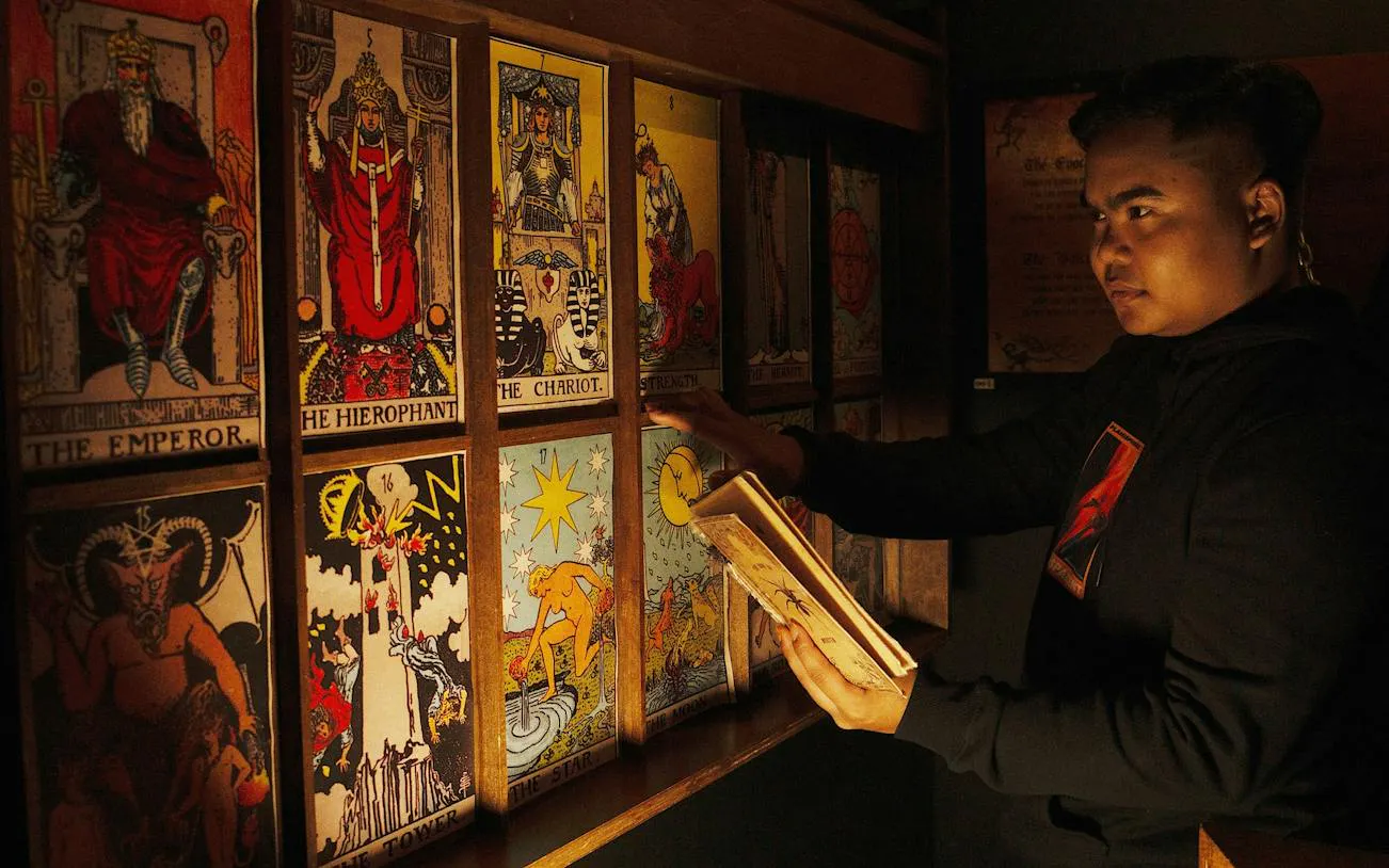 Person examining tarot cards in an escape room setting, Breakout NU Sentral, Dubai.
