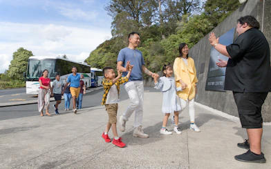 Tour group arriving at Hobbiton Movie Set visitor center, Auckland.