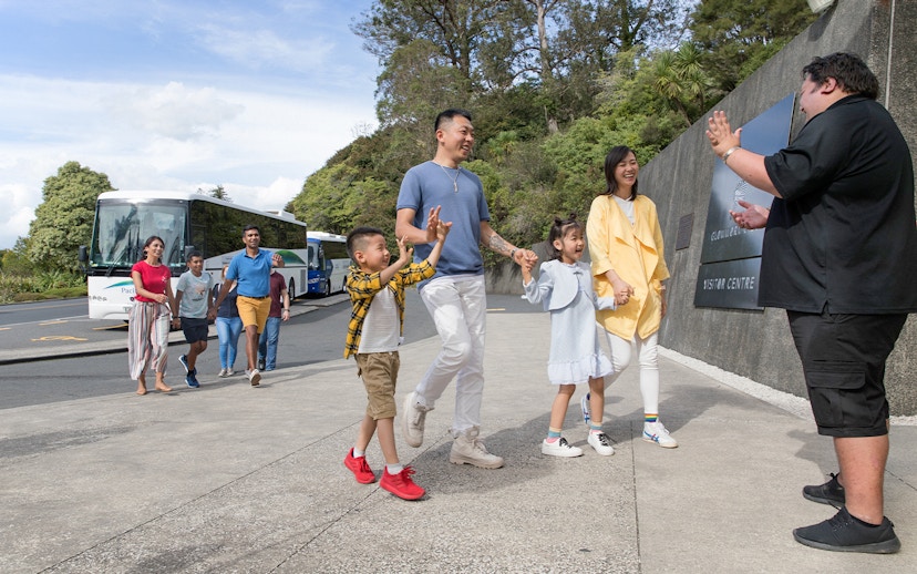 Tour group arriving at Hobbiton Movie Set visitor center, Auckland.