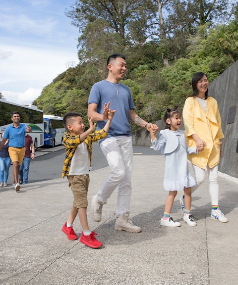 Tour group arriving at Hobbiton Movie Set visitor center, Auckland.