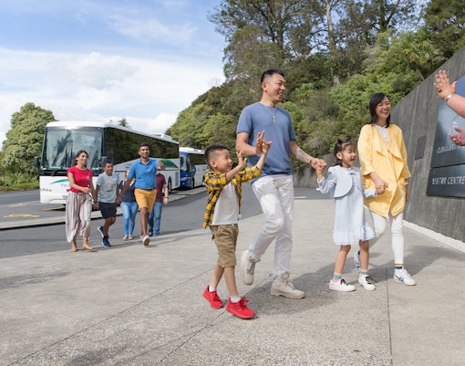 Tour group arriving at Hobbiton Movie Set visitor center, Auckland.