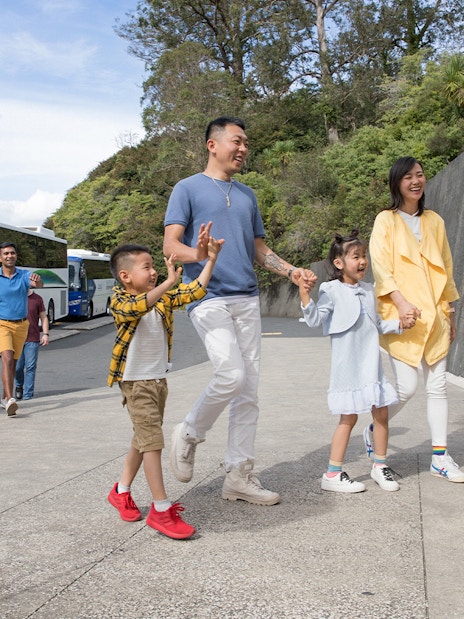 Tour group arriving at Hobbiton Movie Set visitor center, Auckland.