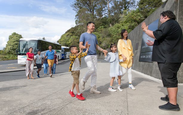 Tour group arriving at Hobbiton Movie Set visitor center, Auckland.