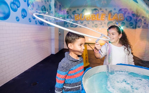 Children playing with giant bubbles at Wonderworks Bubble Lab.