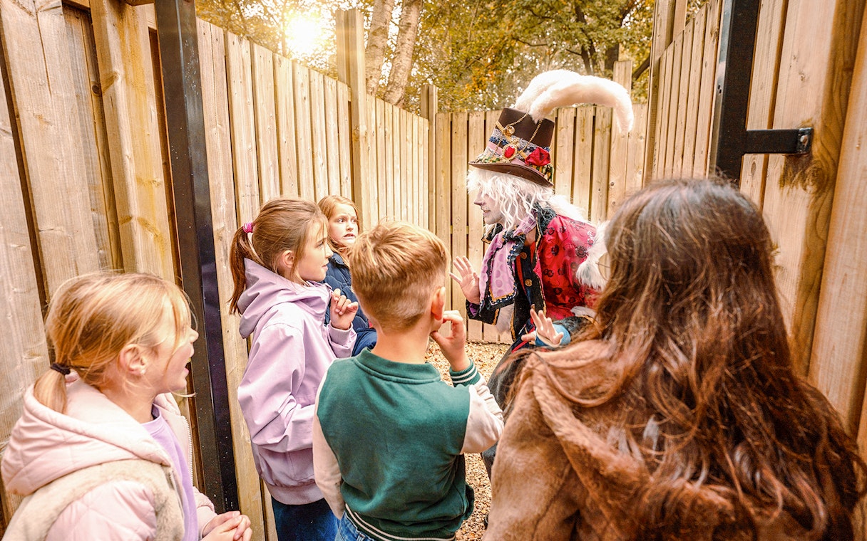 Children interacting with a costumed performer at Halloween event in Bobbejaanland.