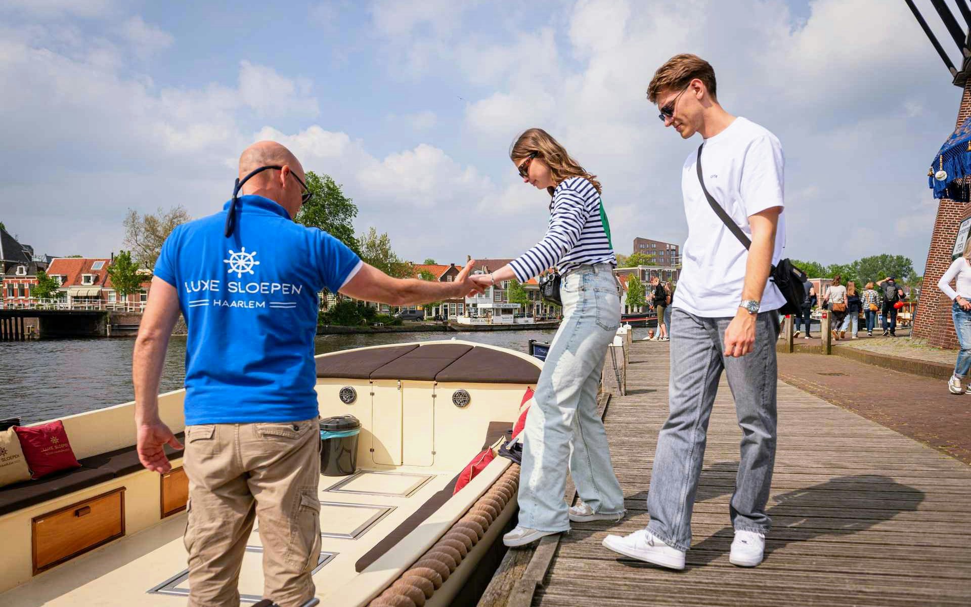 Tourists boarding an open boat for a Harlem canal cruise.
