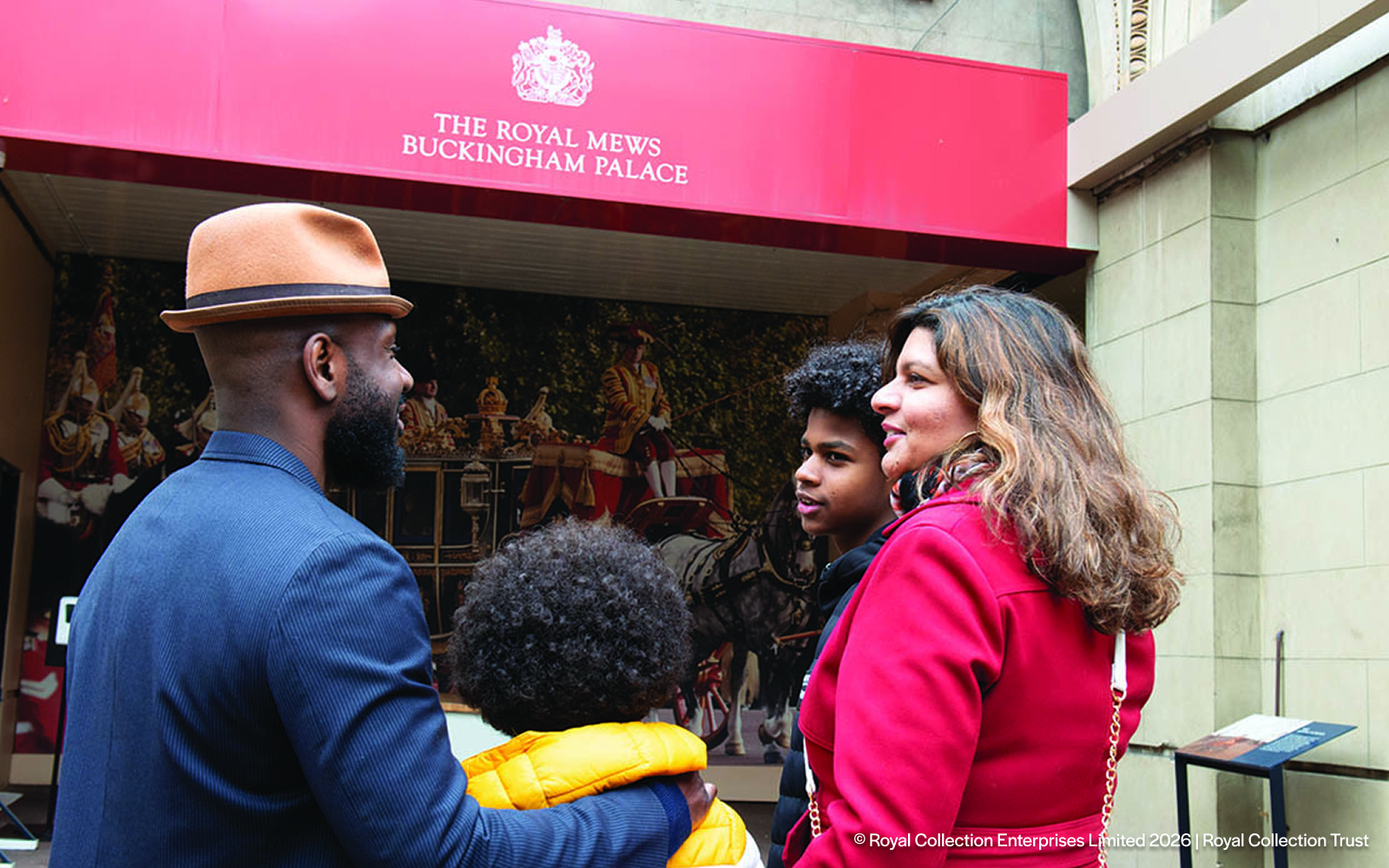 Visitors outside the Royal Mews at Buckingham Palace, London.