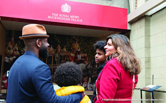 Visitors outside the Royal Mews at Buckingham Palace, London.