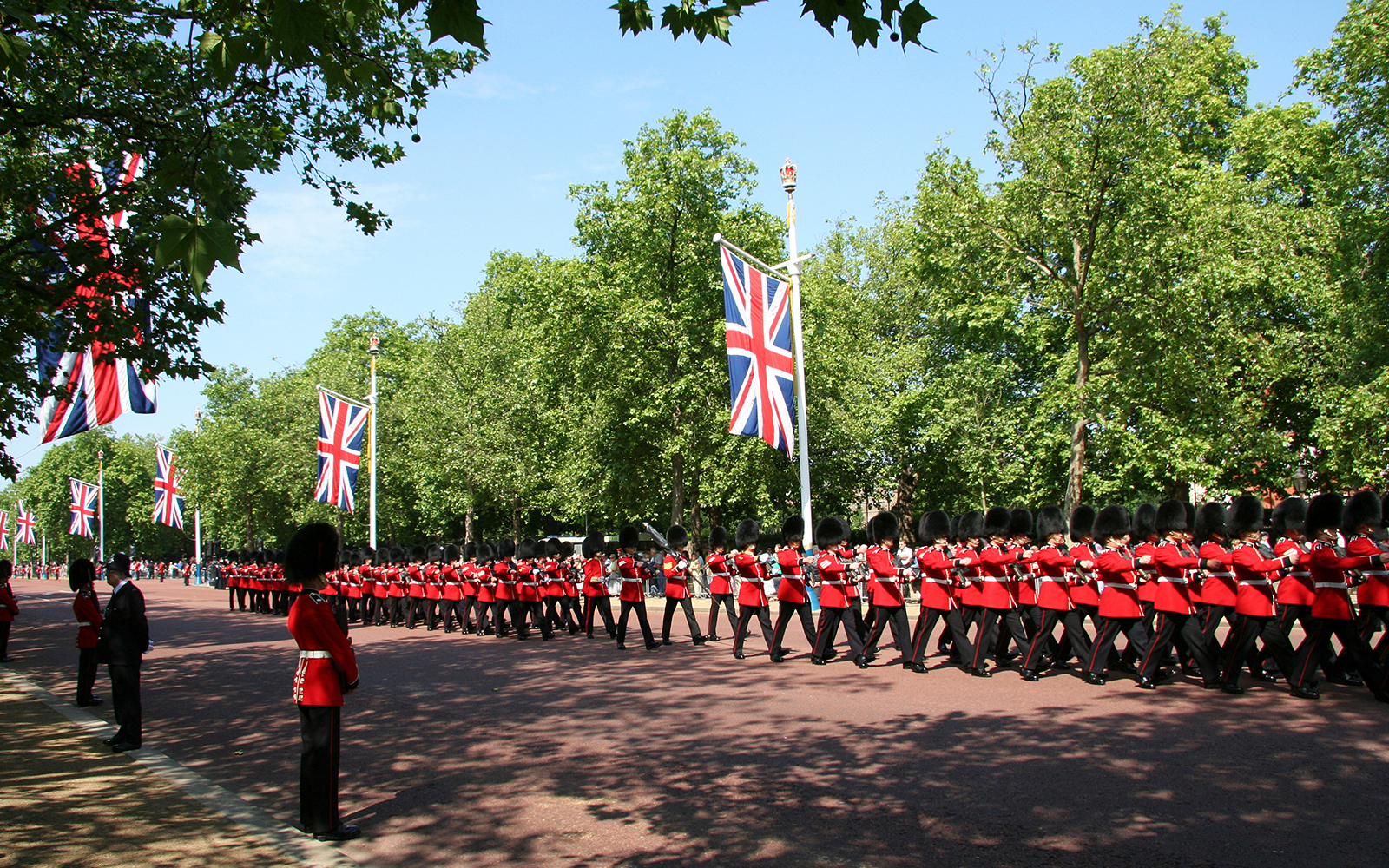 Soldiers in red uniforms marching during Queen's Birthday Parade in London.