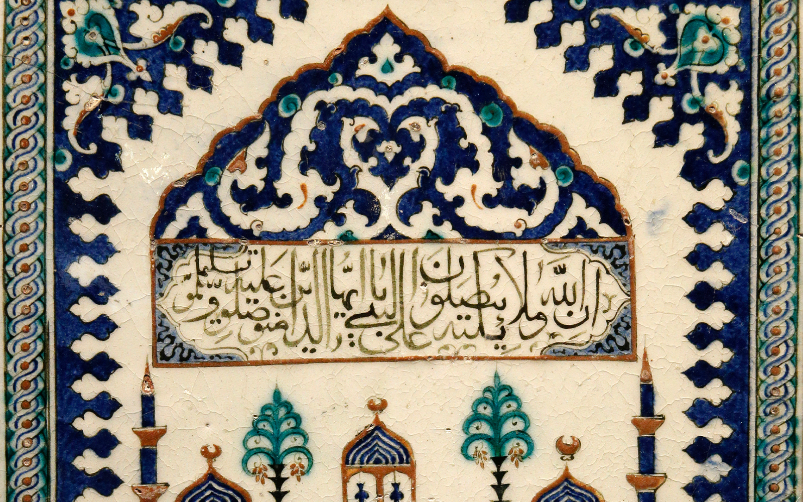 Islamic artwork display at Louvre Museum, Paris, featuring intricate geometric patterns.
