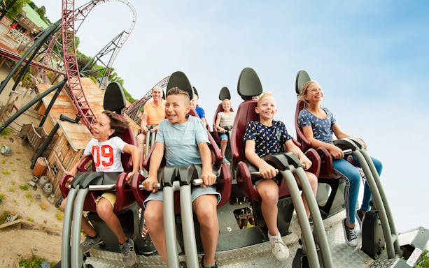Gold Rush rollercoaster at Wild West of Slagharen with riders on steep track.