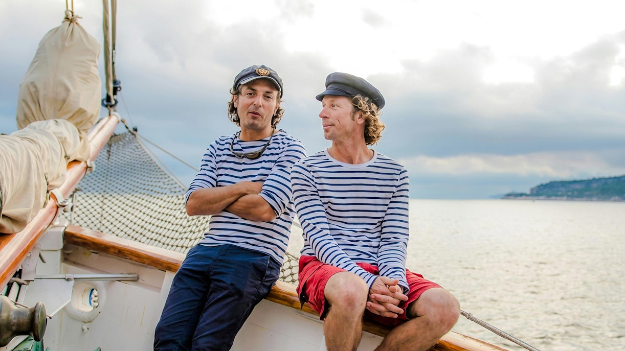 Sailors in striped shirts on a boat during Calanques Exploration Sailing Cruise.