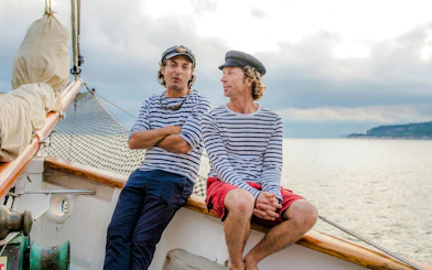 Sailors in striped shirts on a boat during Calanques Exploration Sailing Cruise.